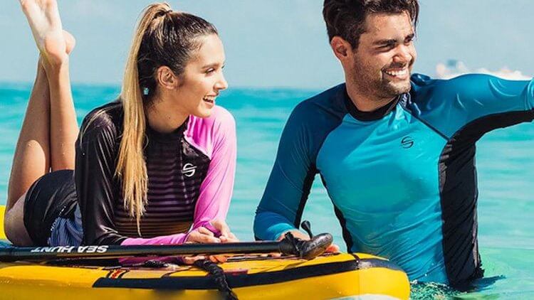 Couple enjoying a sunny day in the water, ready to dive into adventure with snorkeling gear.