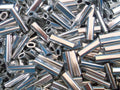 2mm Alli Crimps Size E for 1.8mm Nylon, metallic crimp tubes stacked together.