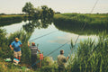 three men fishing during day