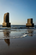 brown concrete building on sea shore during daytime