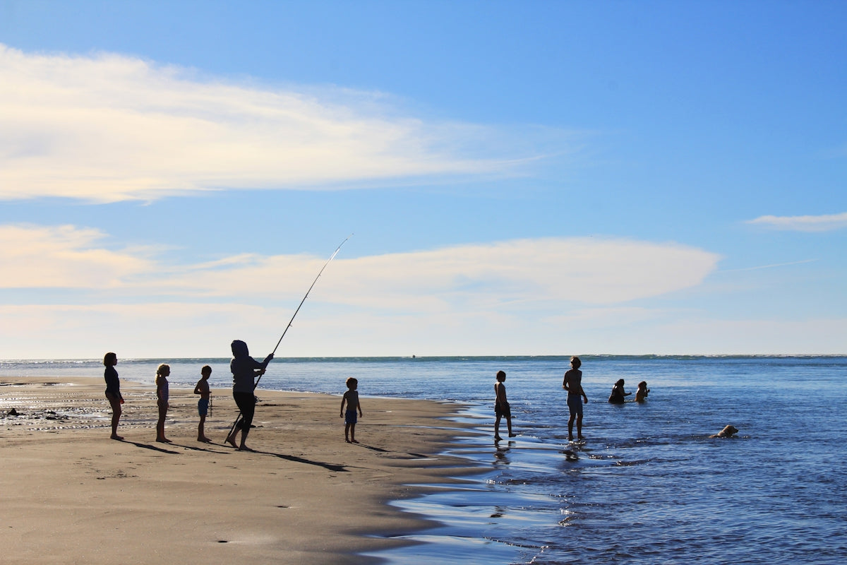 Kids fishing on the beach, showcasing activities related to NZ Made Flounder Beach Drag Nets.