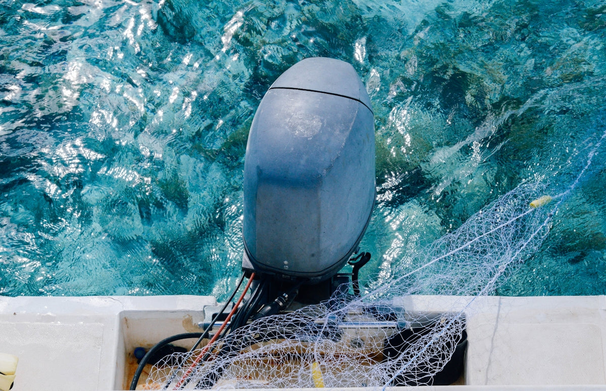 a boat with a fishing net in the water