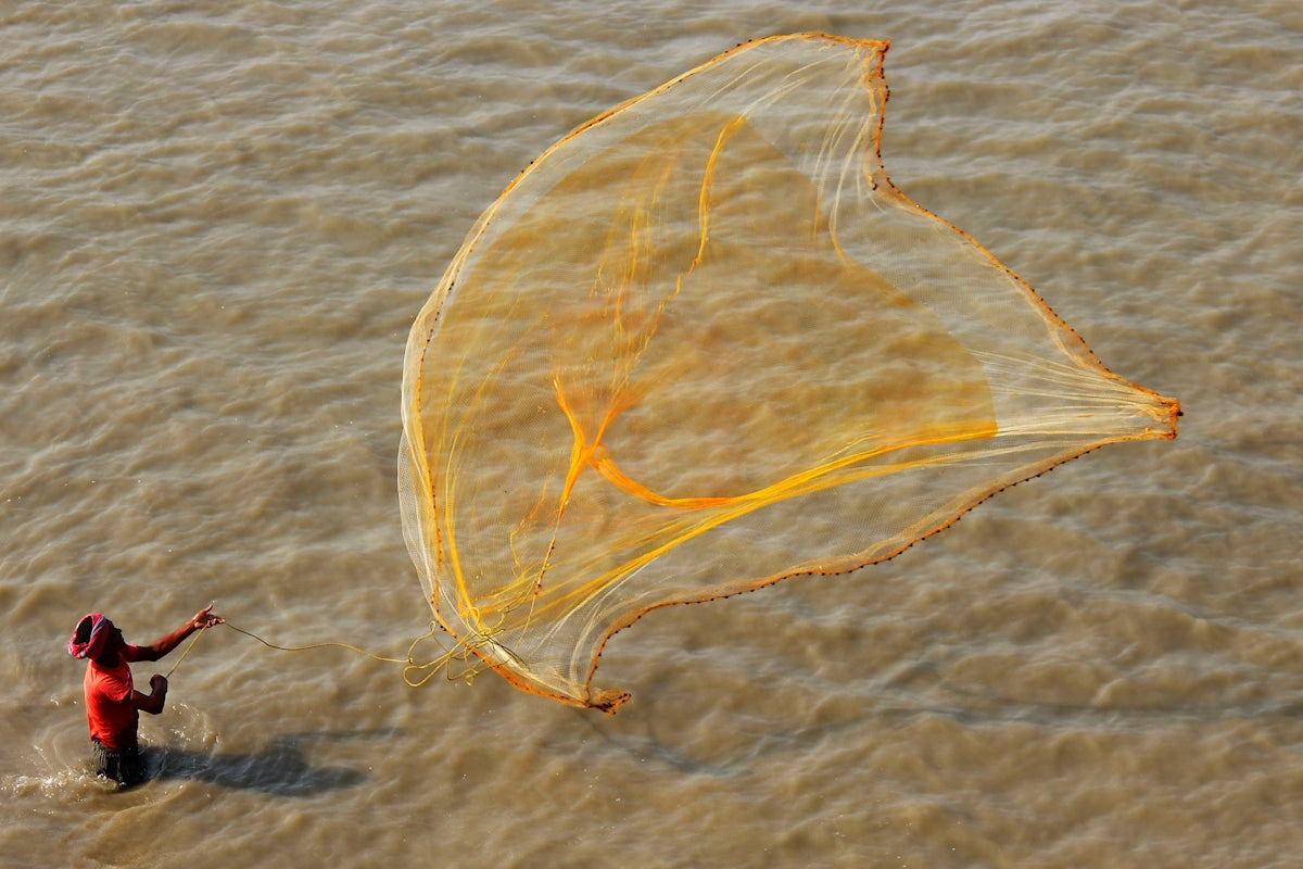 a person holding a large yellow net