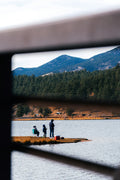 a group of people standing on top of a boat in a lake