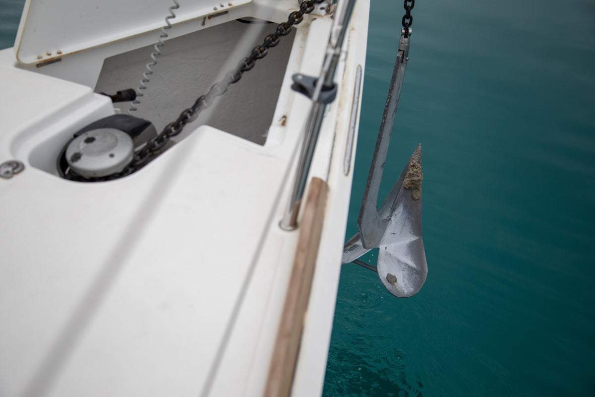 a white boat with a chain hanging off of it's side