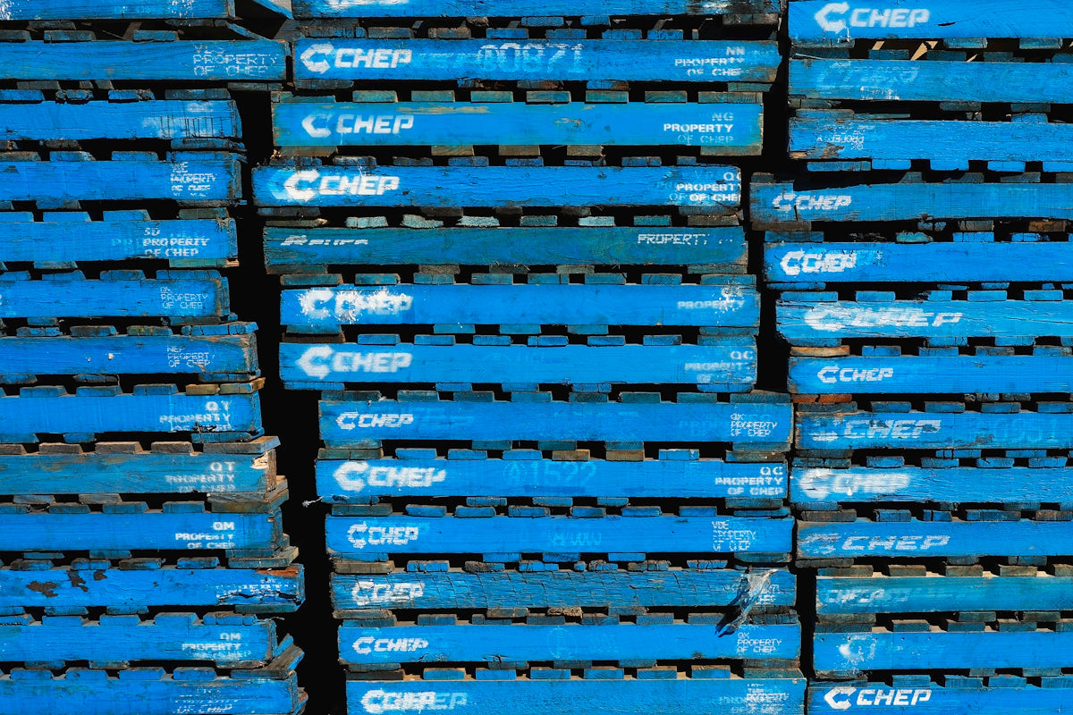 Stacked blue pallets with CHEP branding representing industrial storage solutions.