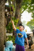 a young boy holding onto a fishing pole