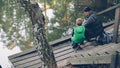 A father and son fishing together by the lake.