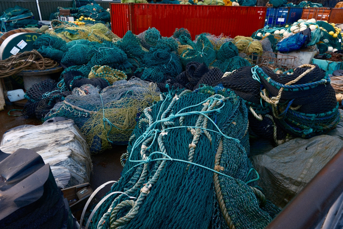 Pile of tangled fishing nets on a dock