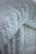 Thick ice formations on a railing in winter