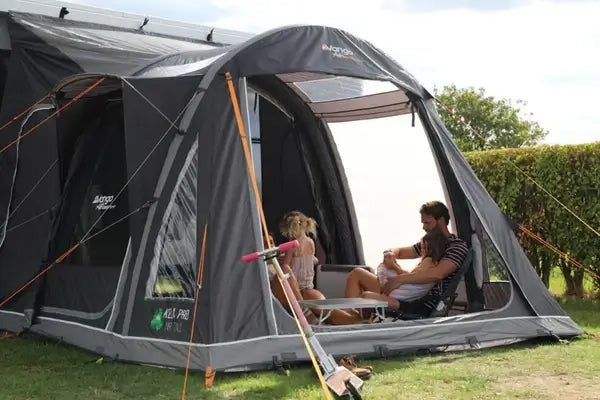 Vango Kela Pro Air Tall Drive Away Awning showcasing a family enjoying their time outdoors in a spacious awning.