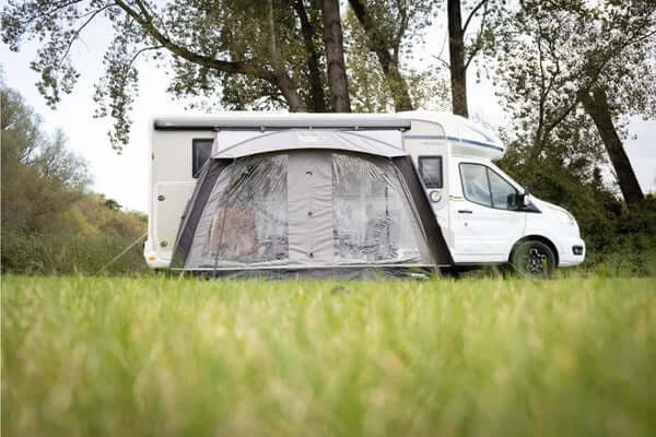 Vango Sunlight Air 380 Elements Proshield awning canopy set up beside a campervan in a grassy outdoor location.
