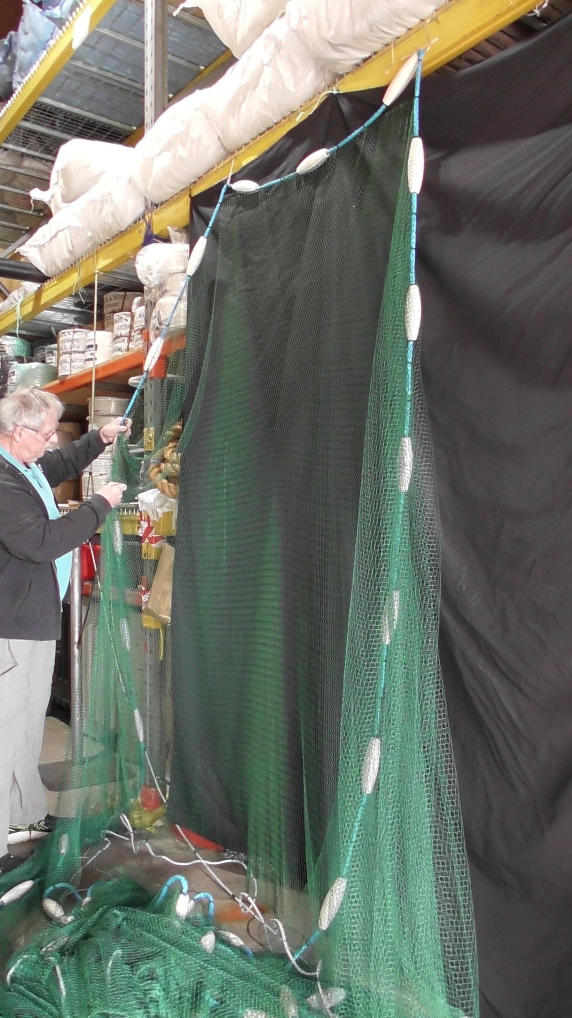 90m Commercial Floating Piper Net being showcased in a warehouse, designed for commercial fishers targeting schooling species.