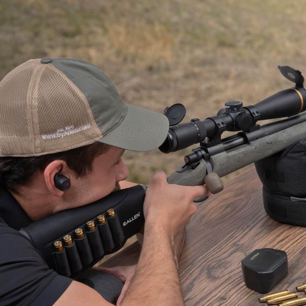 Allen Buttstock Shell Holder in use by shooter aiming at target with rifle on outdoor range.