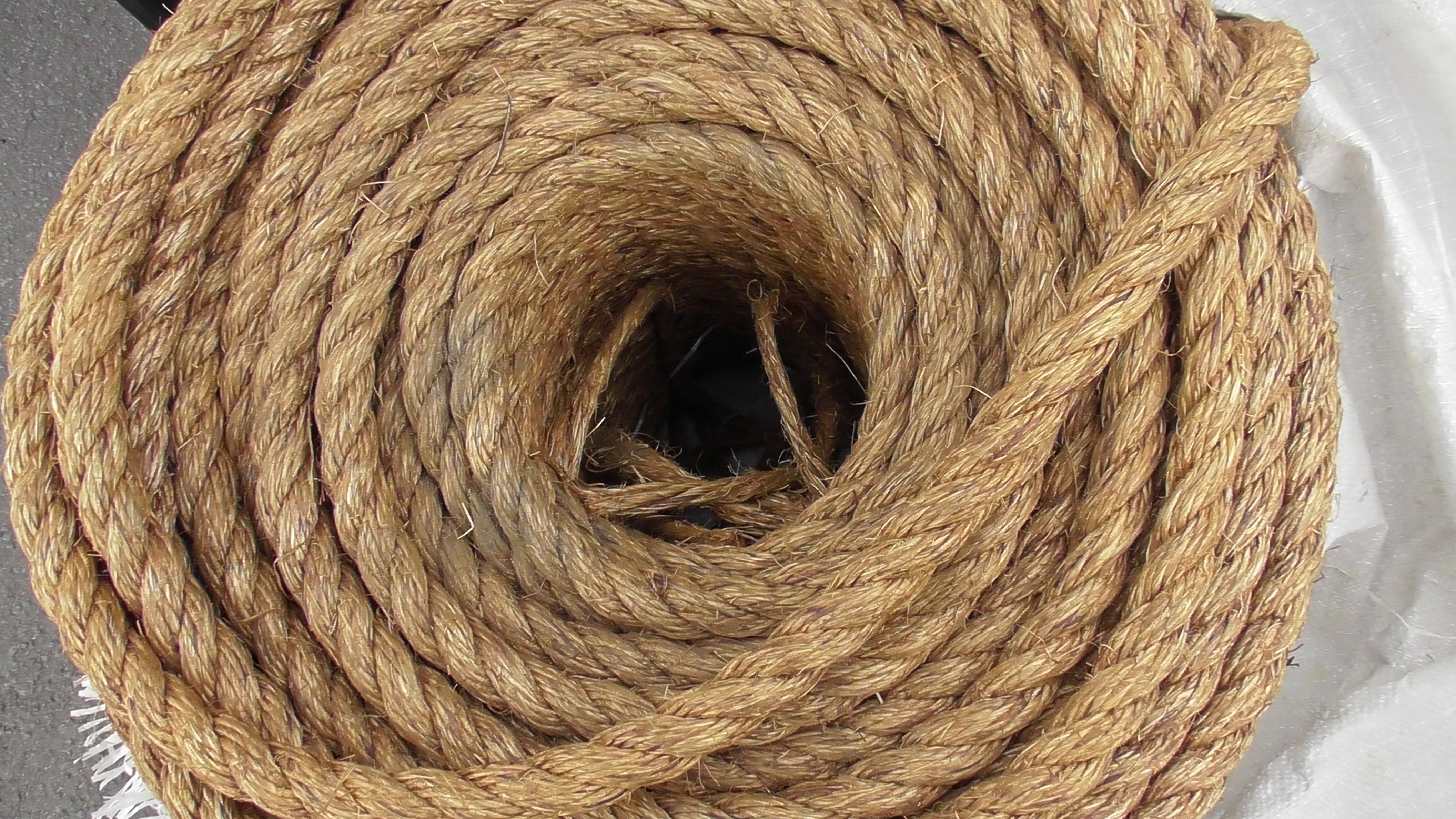 Special Manila Rope 6mm x 250m Coil showing a coiled texture of durable and flexible Manila rope.