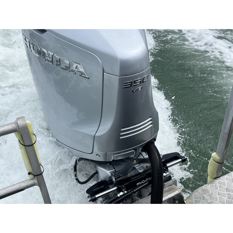 Maxtek Power Hydraulic Steering system installed on Honda 360 V8 outboard motor in water.