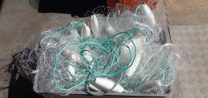 NZ made floating mullet fishing net piled in a container showing its floating design and durable materials.
