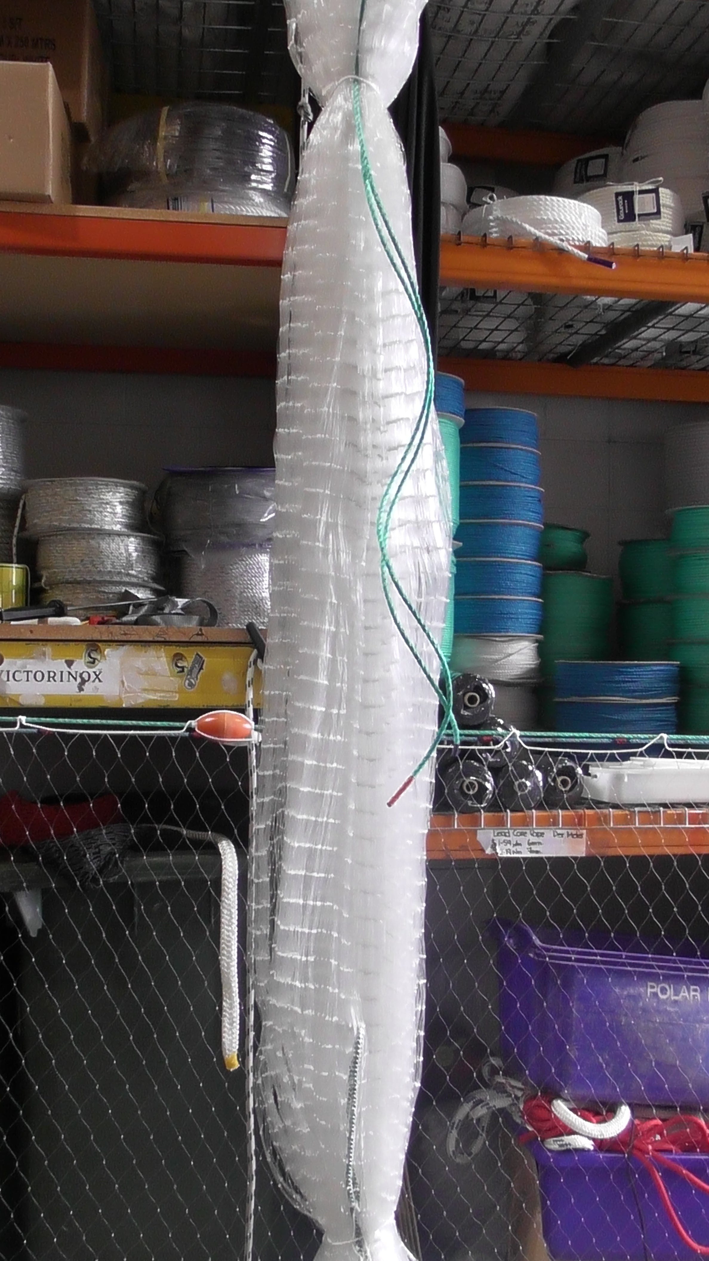 Strong 2-Inch x 0.60 mm Pacific Island Nets hanging in storage, designed for coral and reef fishing, made from 60 lb nylon.