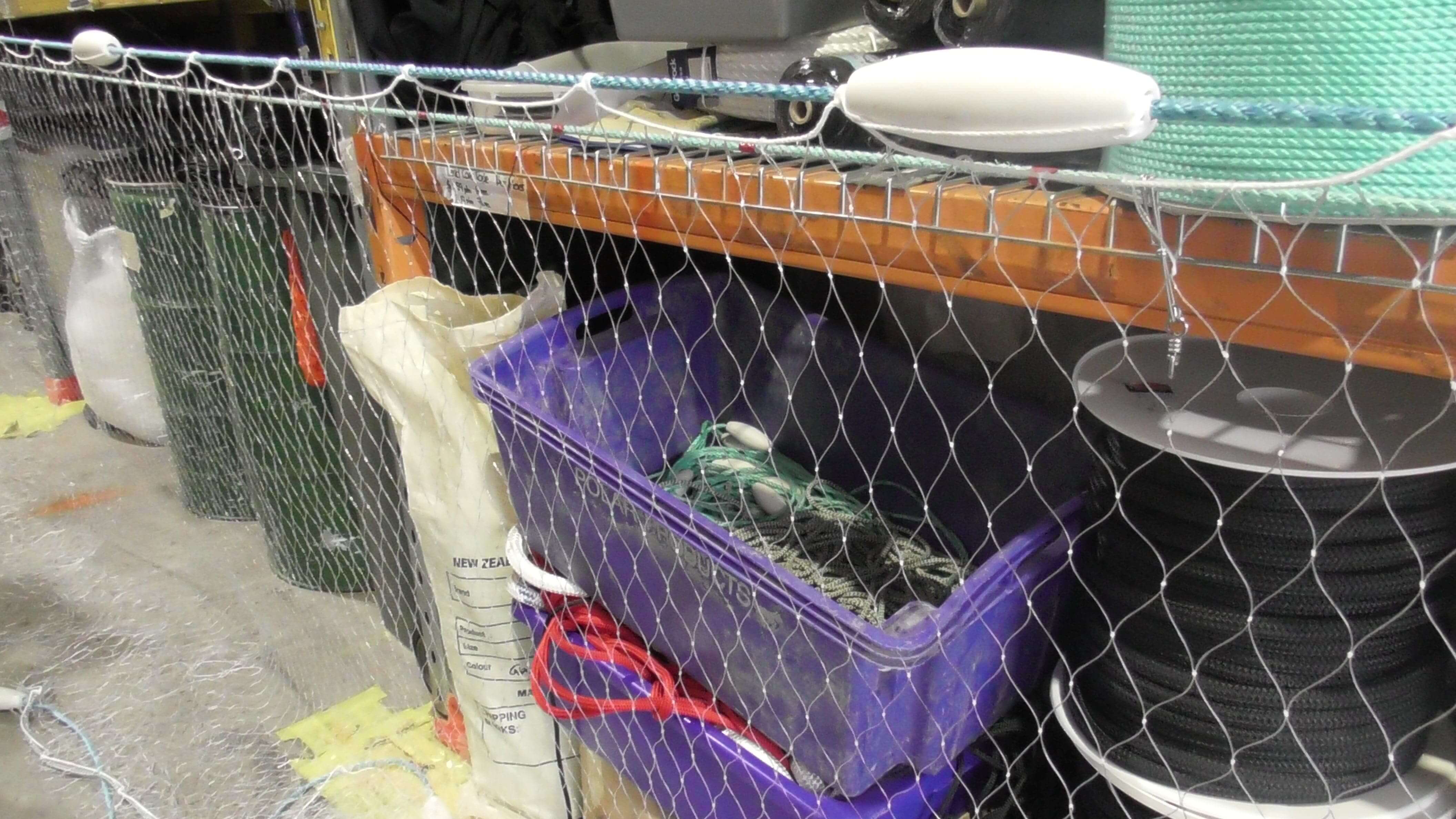 500m Commercial Mullet Fishing net displayed on a shelf with fishing equipment and supplies.