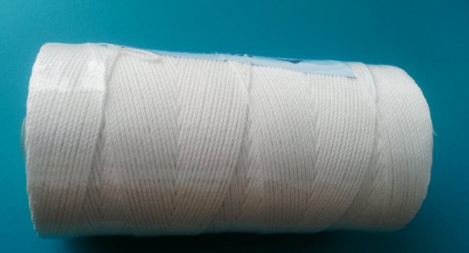 20S-21 Slinging Twine Polyester spool on a blue surface, showcasing high-quality spun polyester twine.