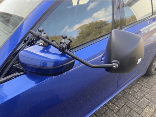 Milenco Platinum Grand Aero Mirrors attached to a blue vehicle, showcasing the innovative design for aerodynamic efficiency.