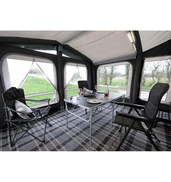 Breathable Fitted Carpet providing comfort in a caravan awning with a dining setup and chairs.