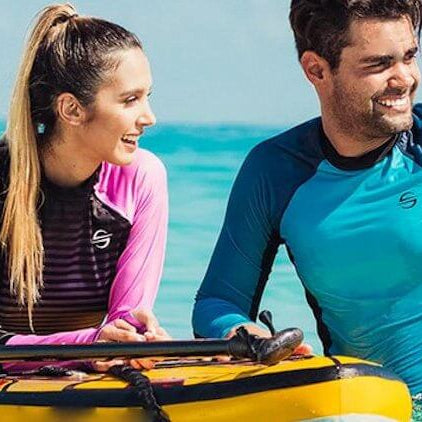 Couple enjoying a sunny day in the water, ready to dive into adventure with snorkeling gear.