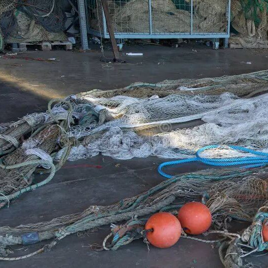 Fishing net accessories laying on the ground, demonstrating how to maintain fishing net accessories action outdoors.