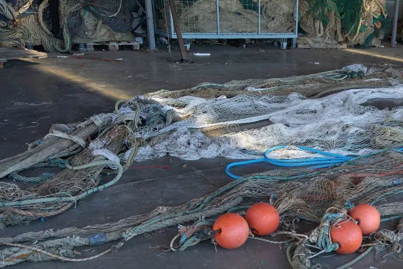 Fishing net accessories laying on the ground, demonstrating how to maintain fishing net accessories action outdoors.