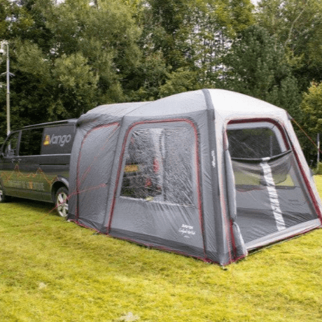 Get Ready for Summer Camping Fun with a cozy tent setup next to a camper van in a green meadow.