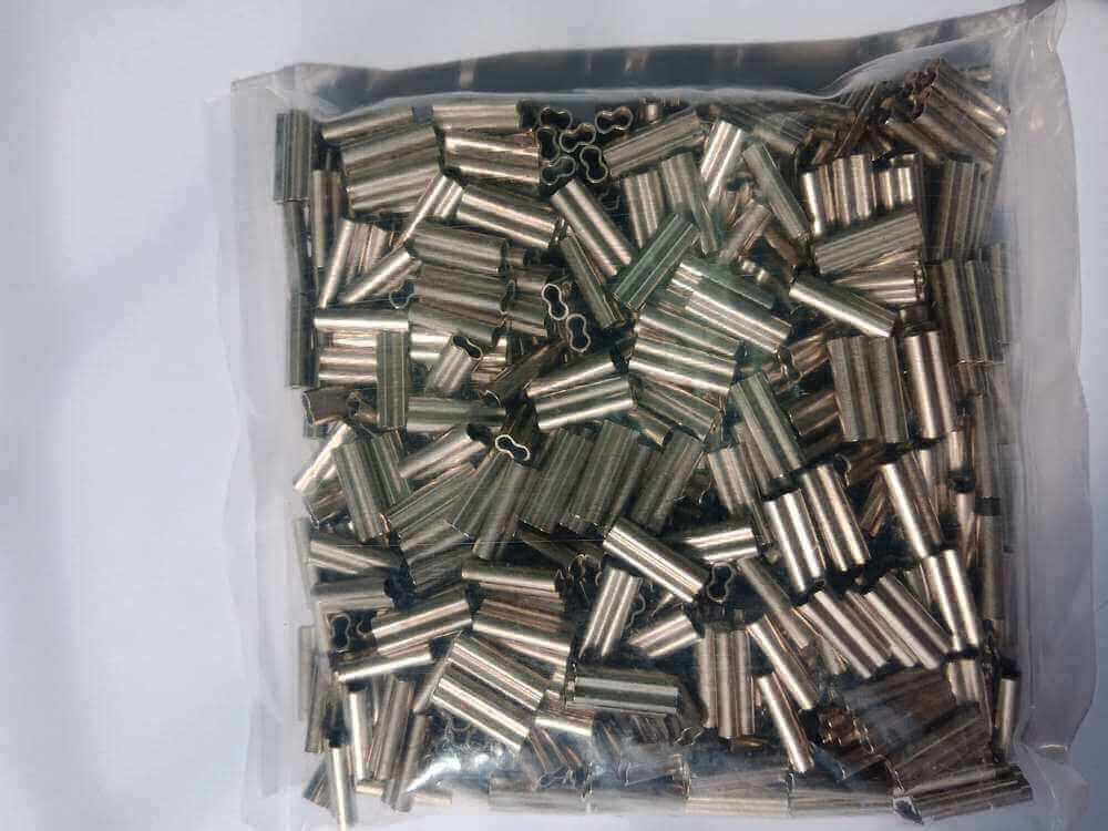 Essential Tips for Using 2.1mm Copper Crimps in a clear bag filled with multiple copper crimps for jewelry crafting.