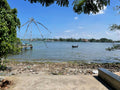 The 60m Net Buoy Anchor Combo 2kg Danforth at a scenic waterfront with a fishing boat.