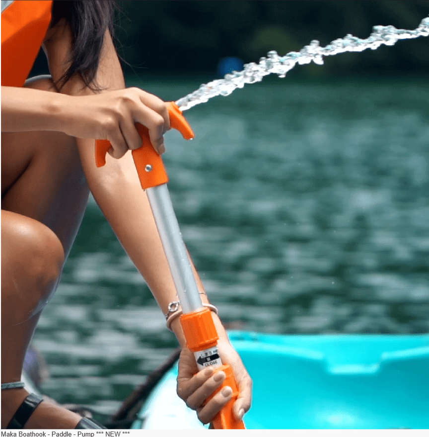 BACK IN STOCK Maka Baasthook Paddle Pump used on kayak with water spraying out.
