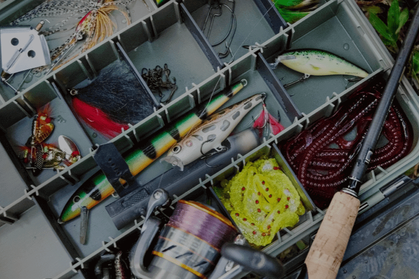 The Essential Nearest Bait and Tackle Shop Guide 2025 showcases assorted fishing lures and tackle in an organized box.