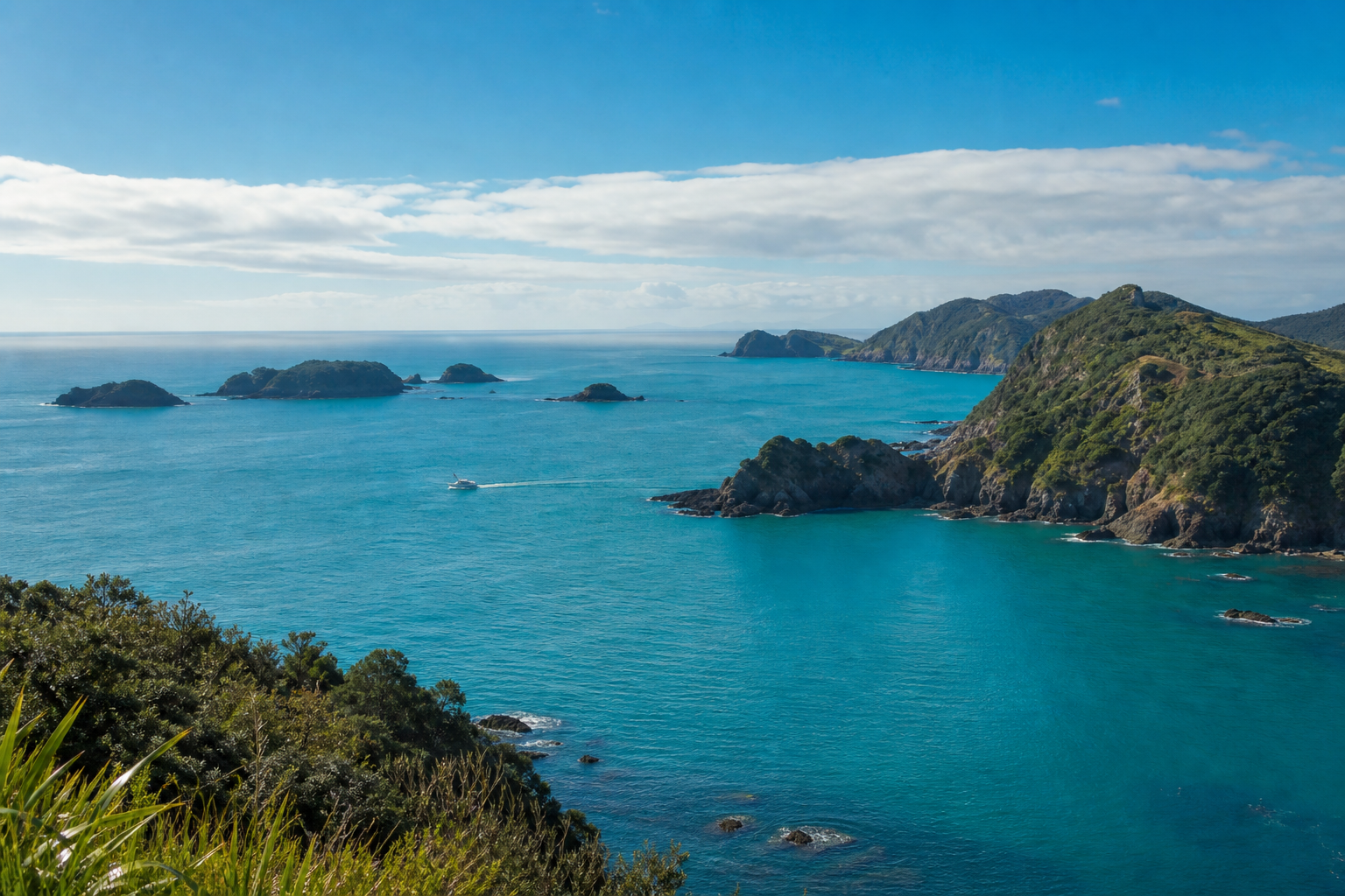 Bay of Islands coastline with islands and a small fishing boat