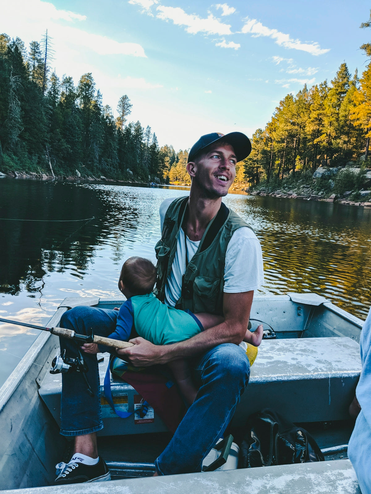 man riding on boat while carrying baby