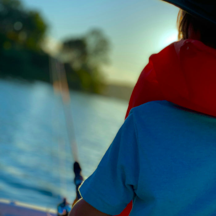 a person on a boat with a fishing rod