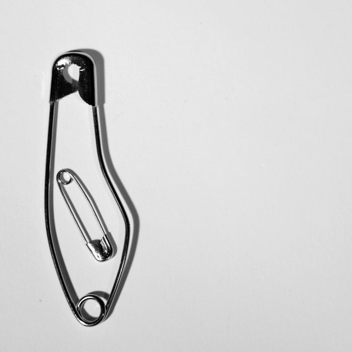 two gray stainless steel safety pins