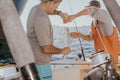 photography of man holding fish during daytime