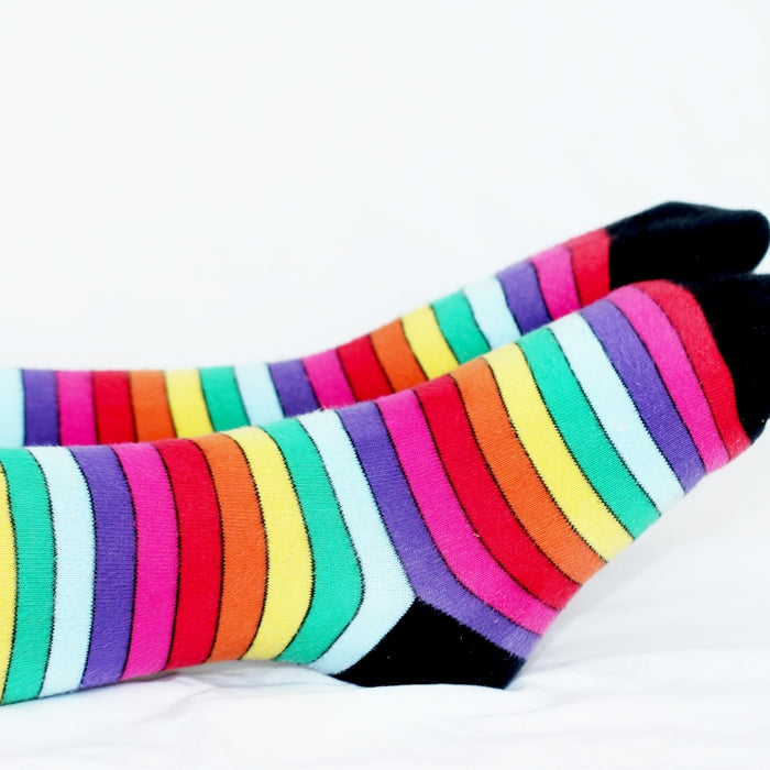 a pair of colorful socks sitting on top of a bed