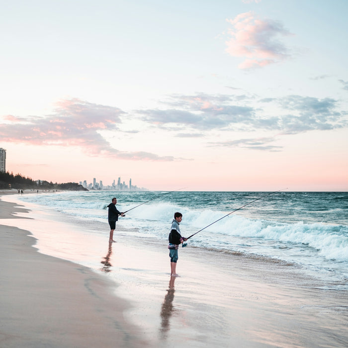 2 women walking on beach during sunset