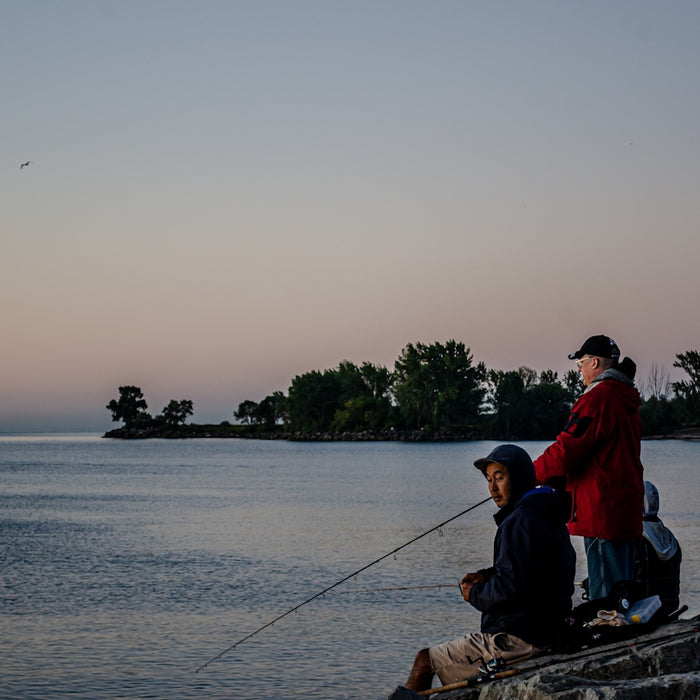 man in red shirt sitting on boat during daytime