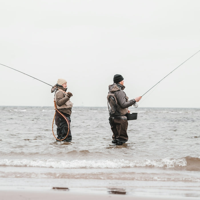 2 men fishing on sea during daytime