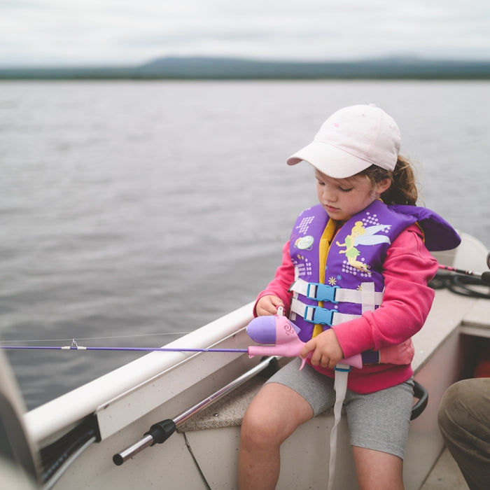 woman in blue and red jacket sitting on boat during daytime