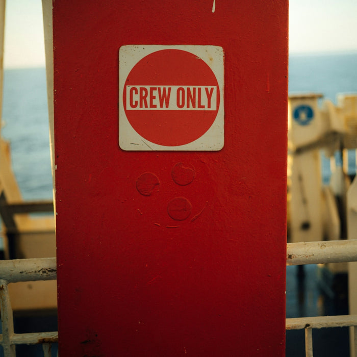 a red box with a sticker that says crew only