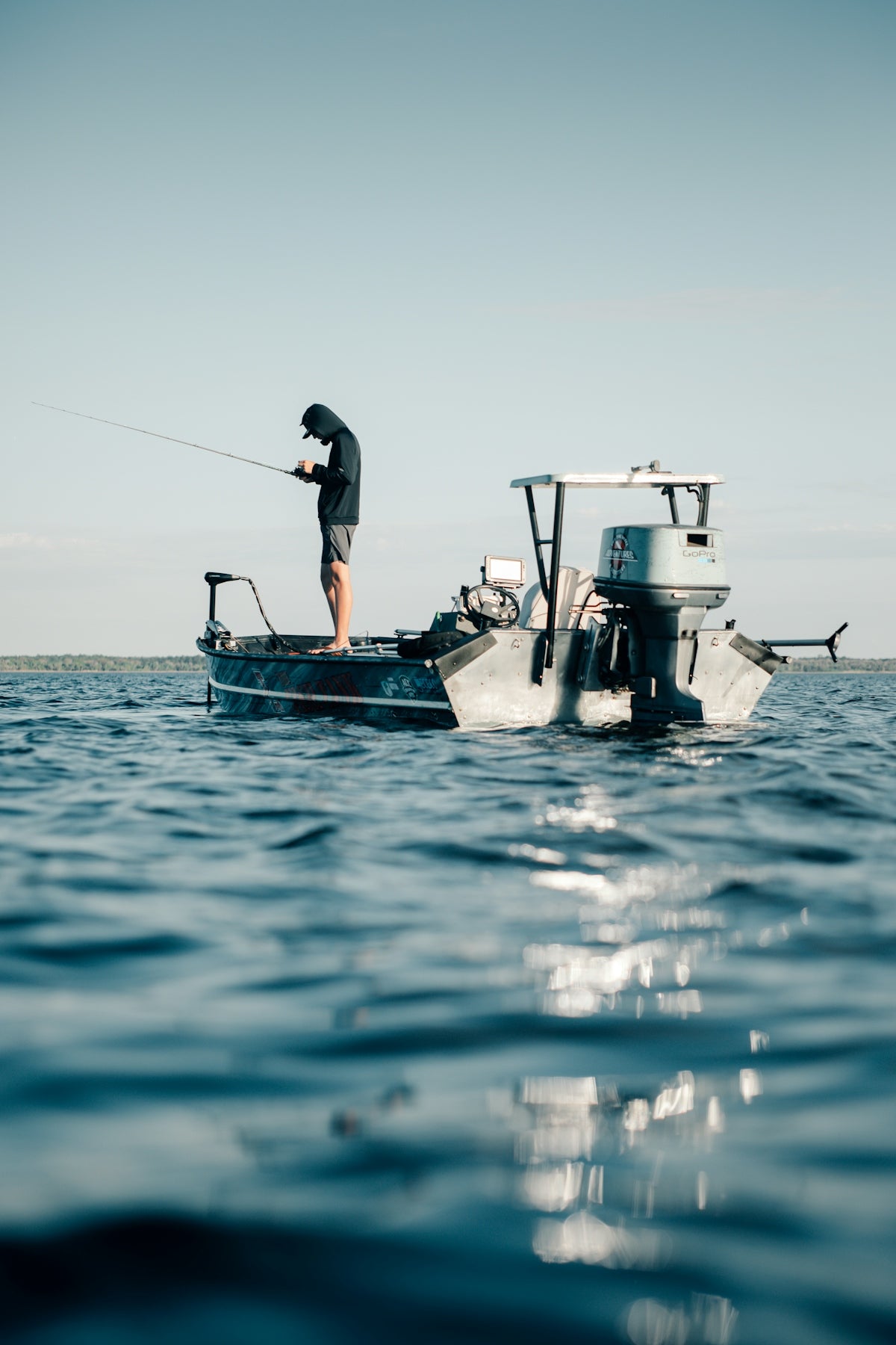 a man fishing on a small boat in the ocean