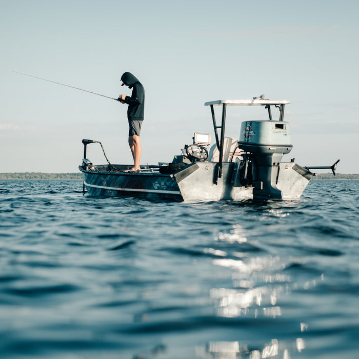 a man fishing on a small boat in the ocean