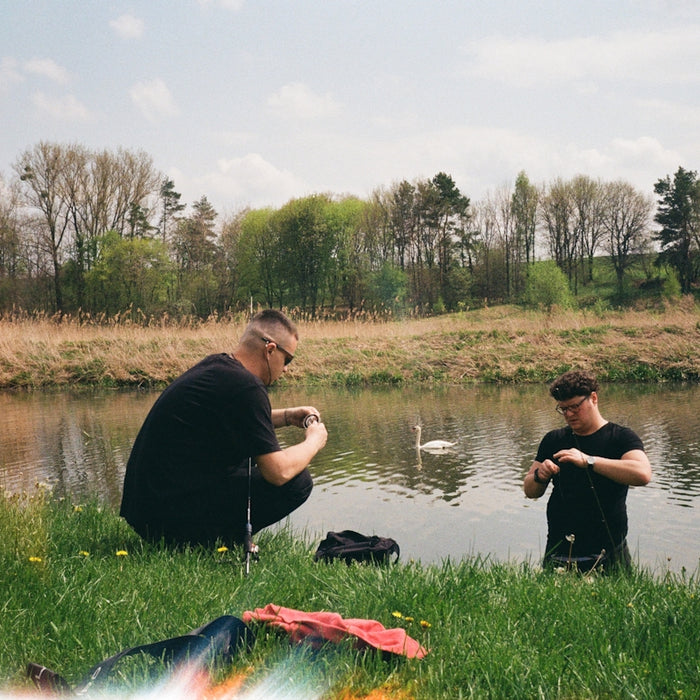 two men fishing in a river