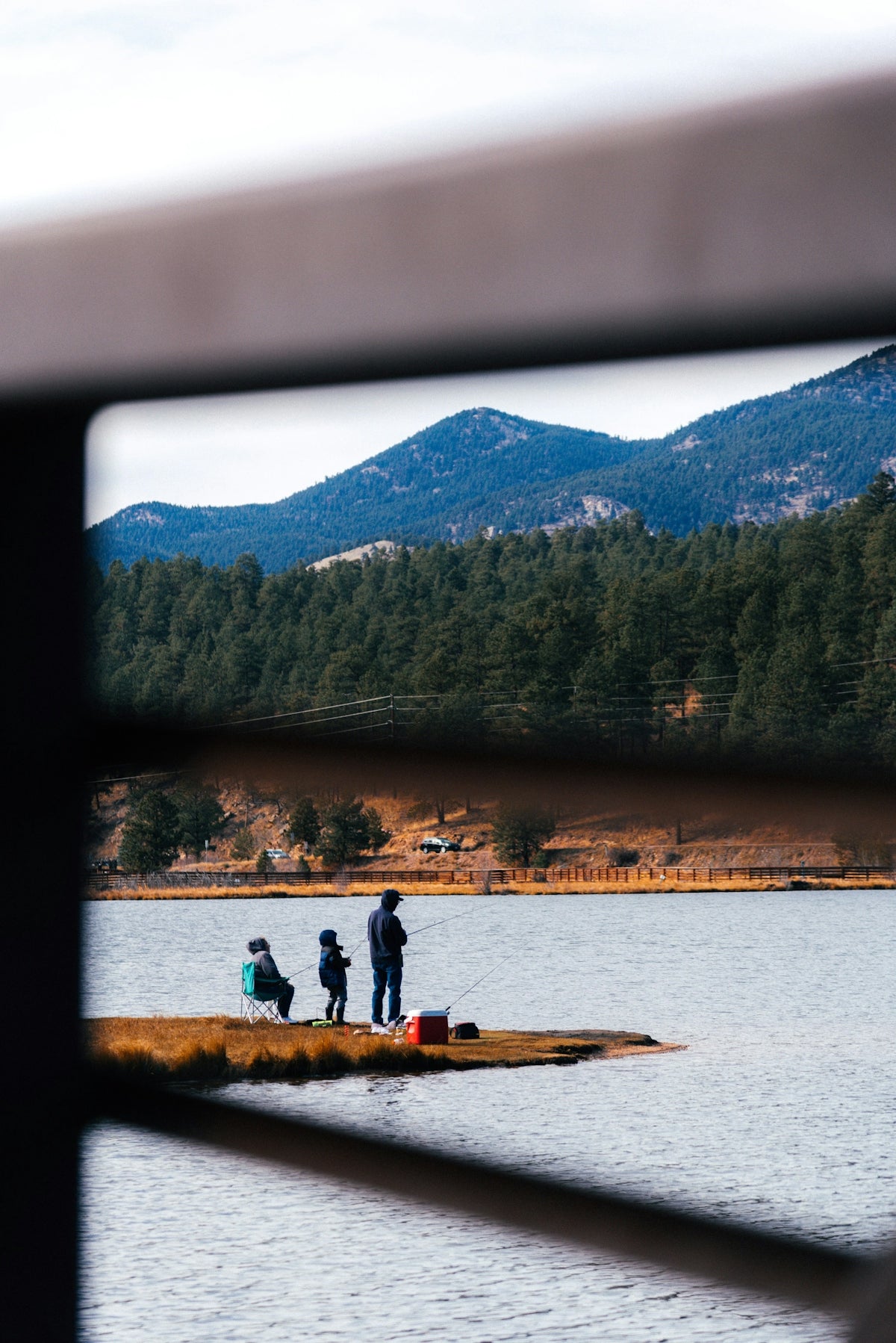 a group of people standing on top of a boat in a lake