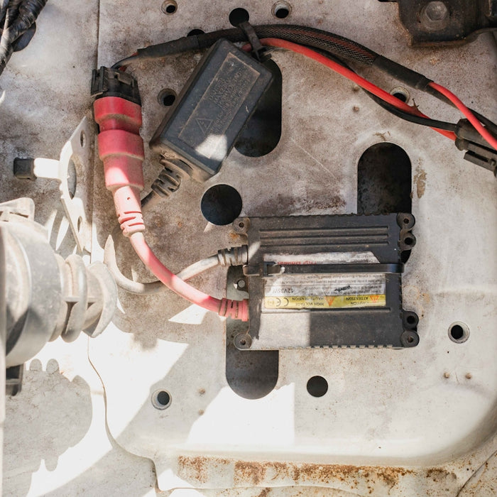 a close up of a car's battery and wires